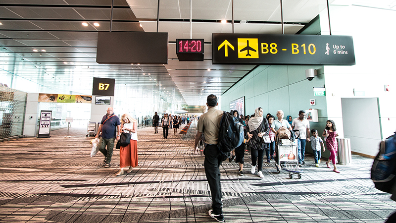 Travellers walking to their boarding gate at Changi Airport